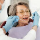 Geriatric dental care concept - senior woman sitting in a dentist chair