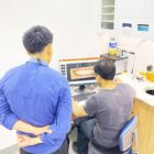 Cosmetic dentist showing patient digital smile makeover preview on screen
