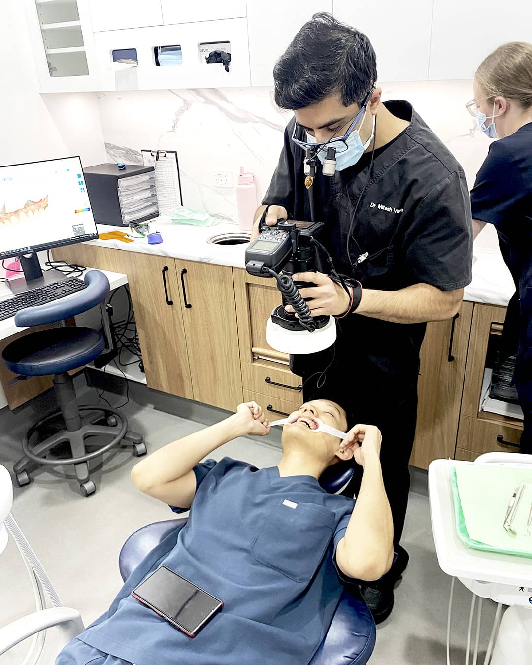 Dr. Mitesh documenting smile makeover progress