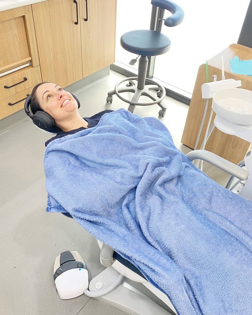 Warm Fleece Blanket draped over a patient during treatment. This creates a cosy, home-like environment. Perfect if you have a long procedure. Ask our Bellara dental team about trying this complimentary comfort item.