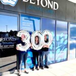 Beyond Dental Care Burpengary team celebrating 300 patient reviews milestone outside clinic entrance