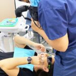 Dentist photographing patient teeth after veneer placement at Sandstone Point practice