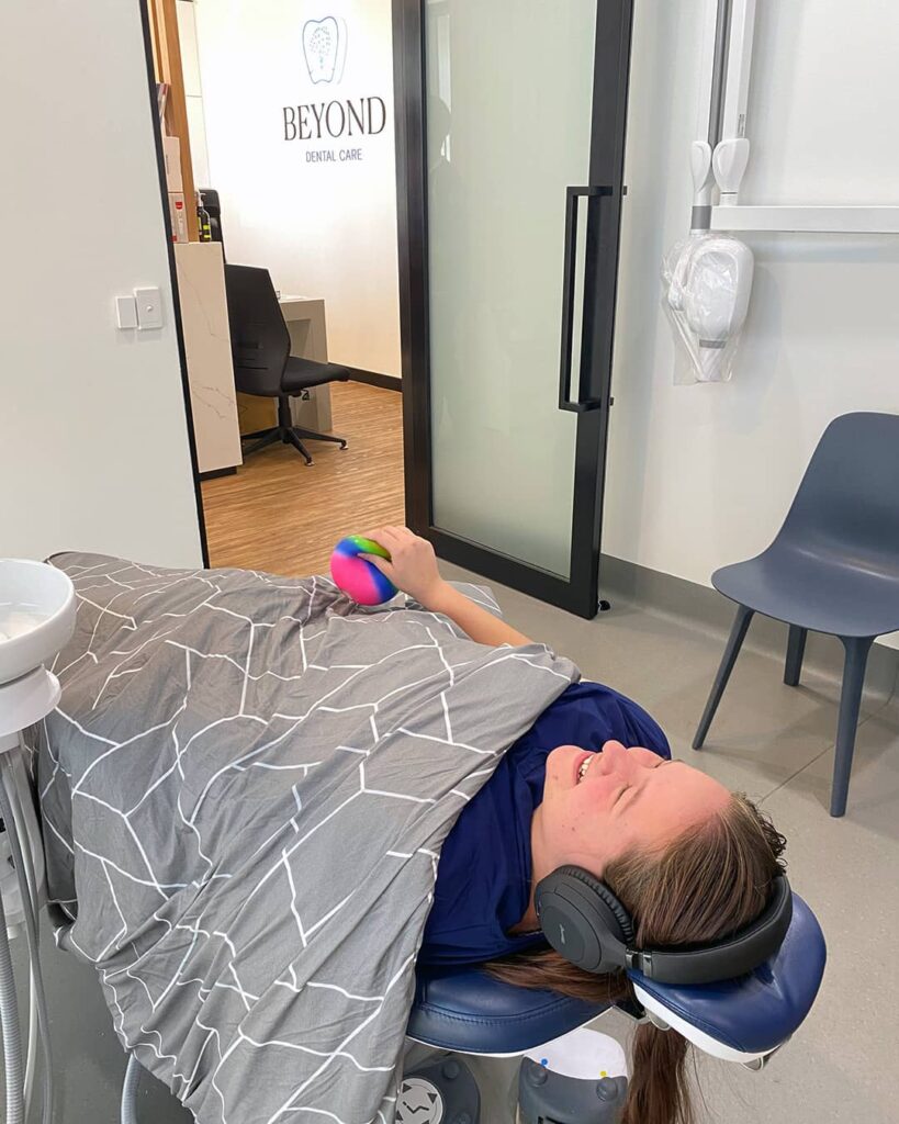 A patient squeezes a stress ball, a simple yet effective technique for easing tension and stress. Complimentary stress ball for patient comfort is available at our Bellara dental practice