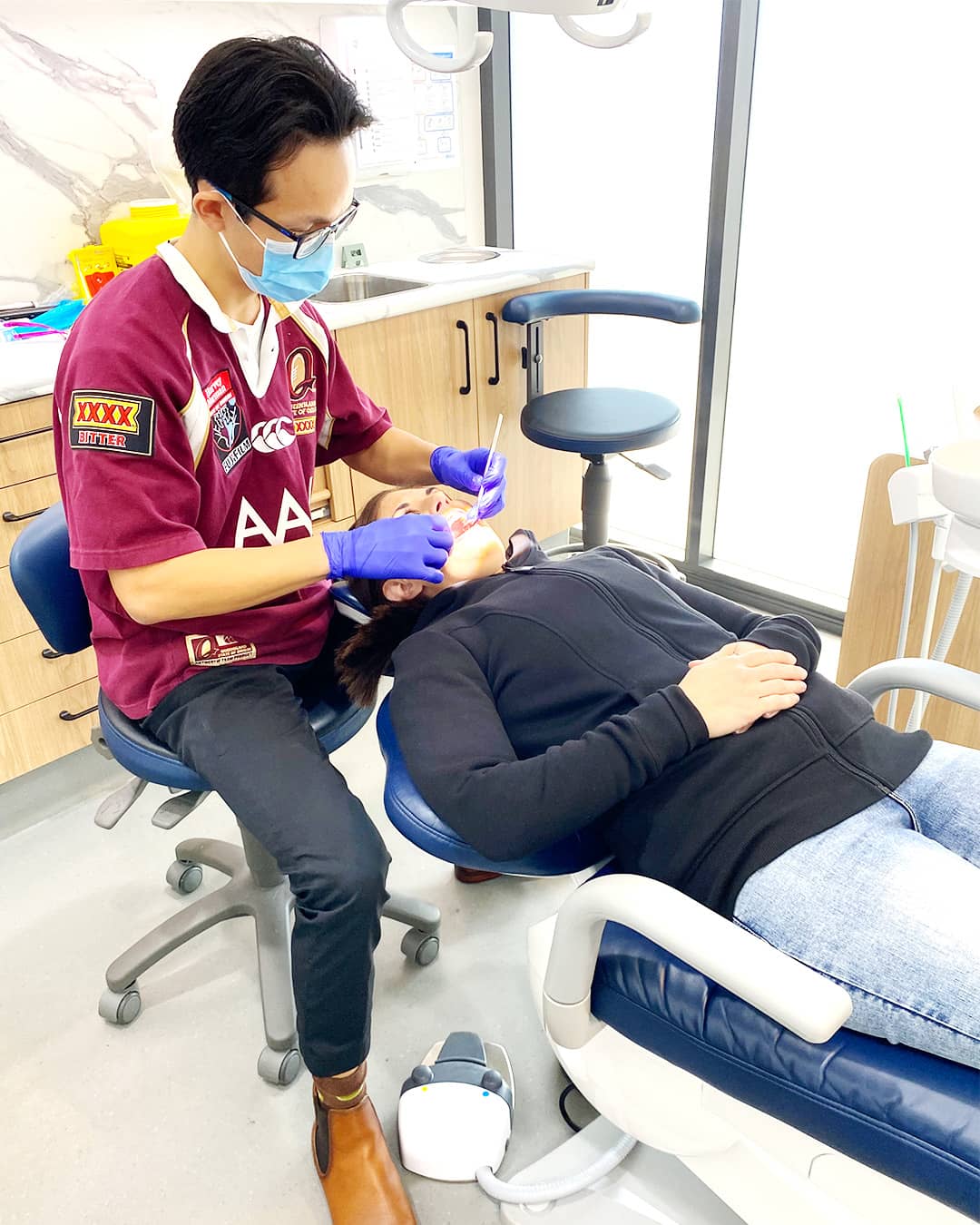 Dr Nick Jin wearing Queensland Maroons jersey during State of Origin 2024