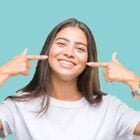 Young female avatar pointing to her teeth