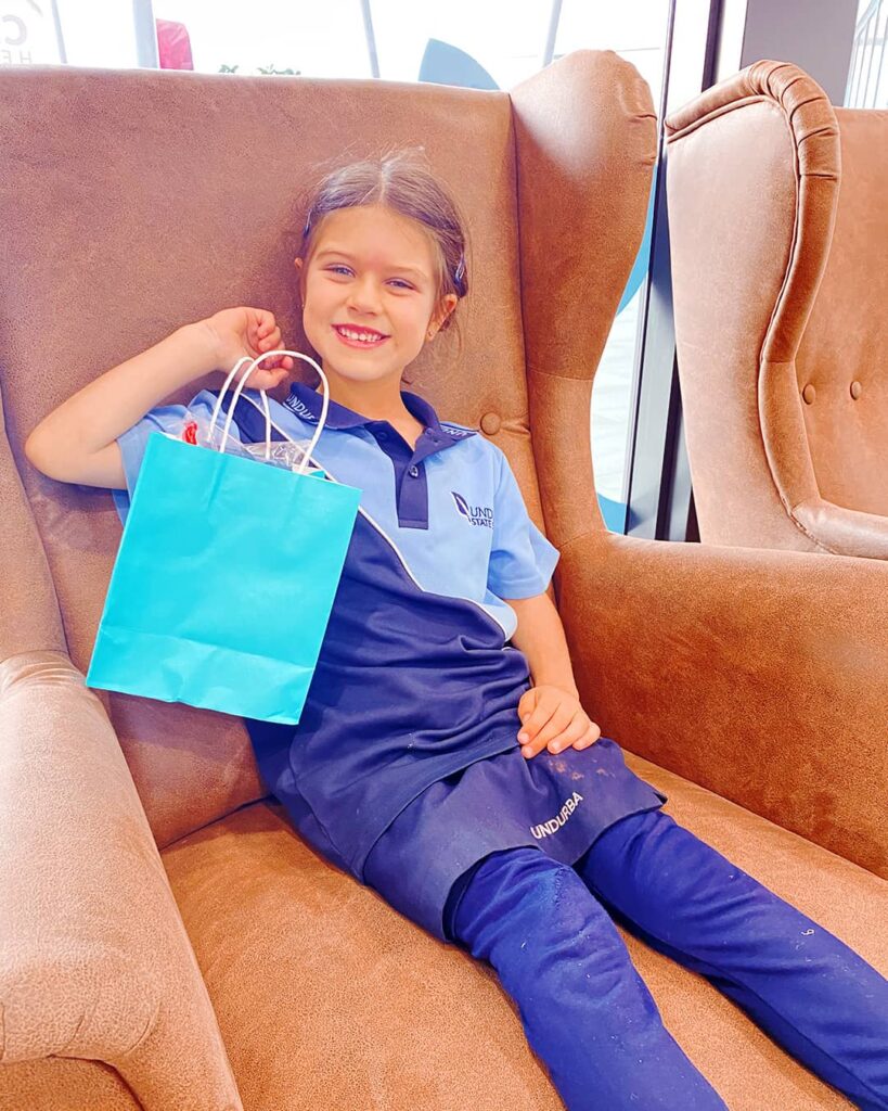 Girl in the chair holding a Gift Bag Kids Dentistry at Beyond Dental Care Girl in the chair holding a Gift Bag Kids Dentistry at Beyond Dental Care